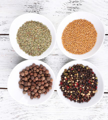 Spice in round bowls on wooden background