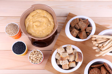 Fondue, little bowls of spice, rusk and biscuits
