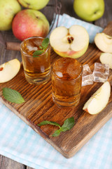 Still life with tasty apple cider in barrel and fresh apples