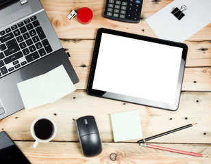 Workplace, laptop and tablet pc on wooden table