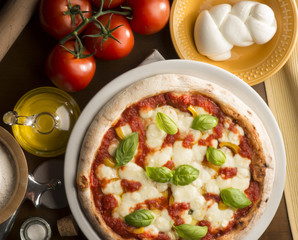 Pizza on the table with ingredients