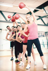Fototapeta premium group of smiling people working out with ball