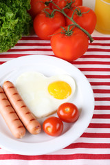 Scrambled eggs with sausage and vegetables served