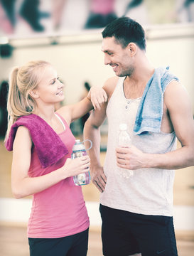 Two Smiling People In The Gym