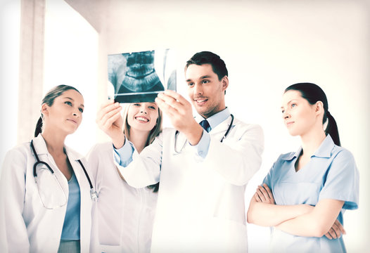 young group of doctors looking at x-ray