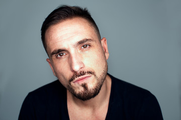 Obraz premium Portrait of Serious Man with Facial Hair in Studio