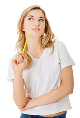 Thoughtful woman with pencil