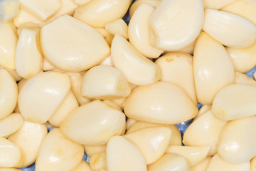 Closeup of peeled cloves of garlic, background
