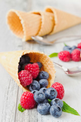 raspberries and blueberries in a waffle cone