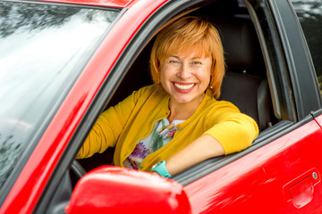 Portrait of older woman driving a car
