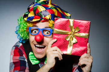 Funny clown with red giftbox