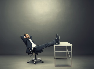 businessman put his feet up on the table