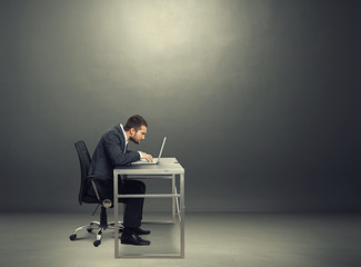 businessman working with laptop in the dark room