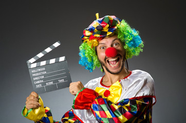 Clown with movie clapper board