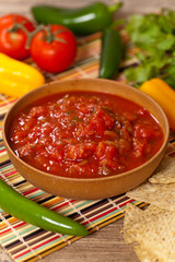 Spicy Red Salsa with tortilla chips. Selective focus.
