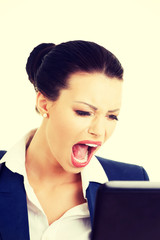Angry businesswoman shouting on her laptop