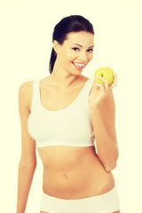 Beautiful woman with clean fresh healthy skin holding green appl