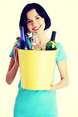 Beautiful young woman holding recycling bin