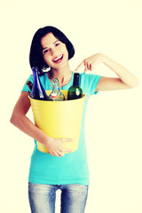 Beautiful young woman holding recycling bin