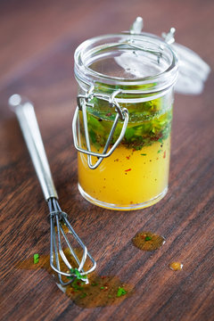 Salad Dressing With Olive Oil Chili And Herbs In A Glass Jar