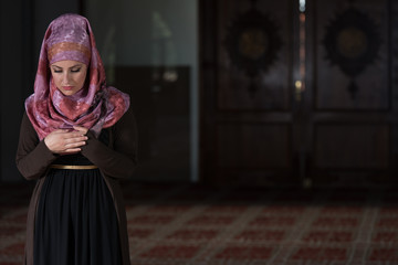 Young Muslim Woman Praying In Mosque