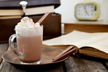 Chocolate with whipped cream with books in the background