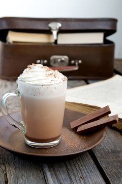 Chocolate with whipped cream with books in the background