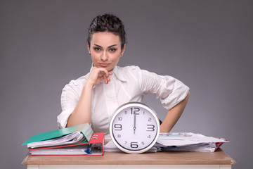 Waist-up portrait of young girl sitting at the table in office