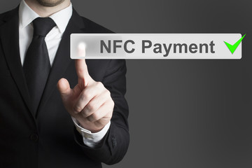 businessman pushing button nfc payment