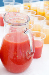 Fresh juice jug on white table