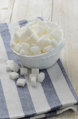 Cubes of sugar in white bowl