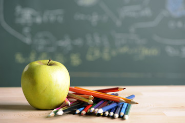 Apple with pencils in classroom