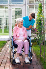 Smiling happy senior lady in a wheelchair.