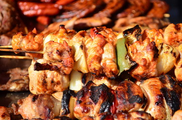 Skewered on wooden sticks tasty pork meat and vegetables mix