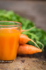 Carrot juice on wooden background