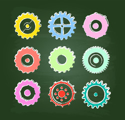 Colored Cog Wheels Icons Set On Green Chalkboard