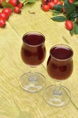 Rosehip fruit and alcoholic liquor in a glasses