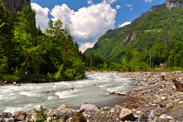 Fototapeta na wymiar Mountain River in Swiss Alps Valley