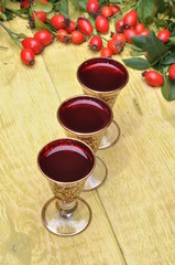 Rosehip fruit and alcoholic liquor in a glasses