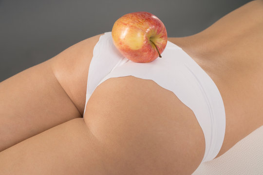 Frau mit einem Apfel auf ihrem Hintern