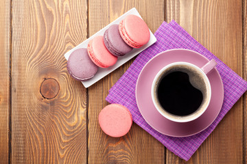 Colorful macaron cookies and cup of coffee