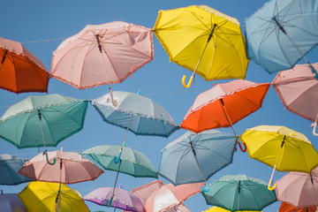 Fototapeta na wymiar different colorful umbrellas on sky