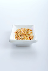sesame seeds on plate isolated over white background