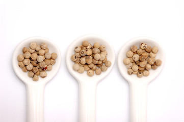 spoons full of black peppercorn