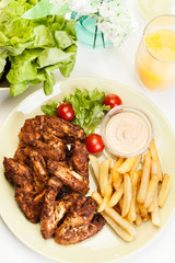 Chicken wings with fries french and spicy sauce