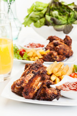 Chicken wings with fries french and spicy sauce