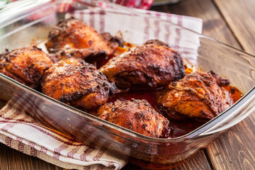 Roasted chicken drumsticks in casserole dish