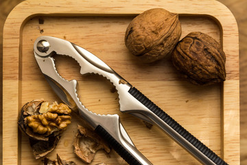 Walnuts and nutcracker on wood table