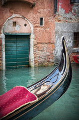 Fototapeta na wymiar Gondola moored on a venetian canal - Venice, Italy, Europe