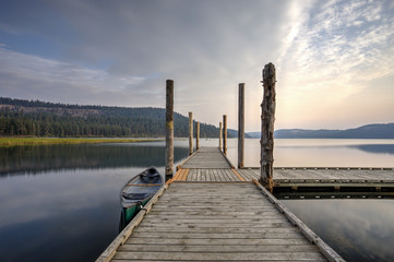 Dock at calm, tranquil lake.